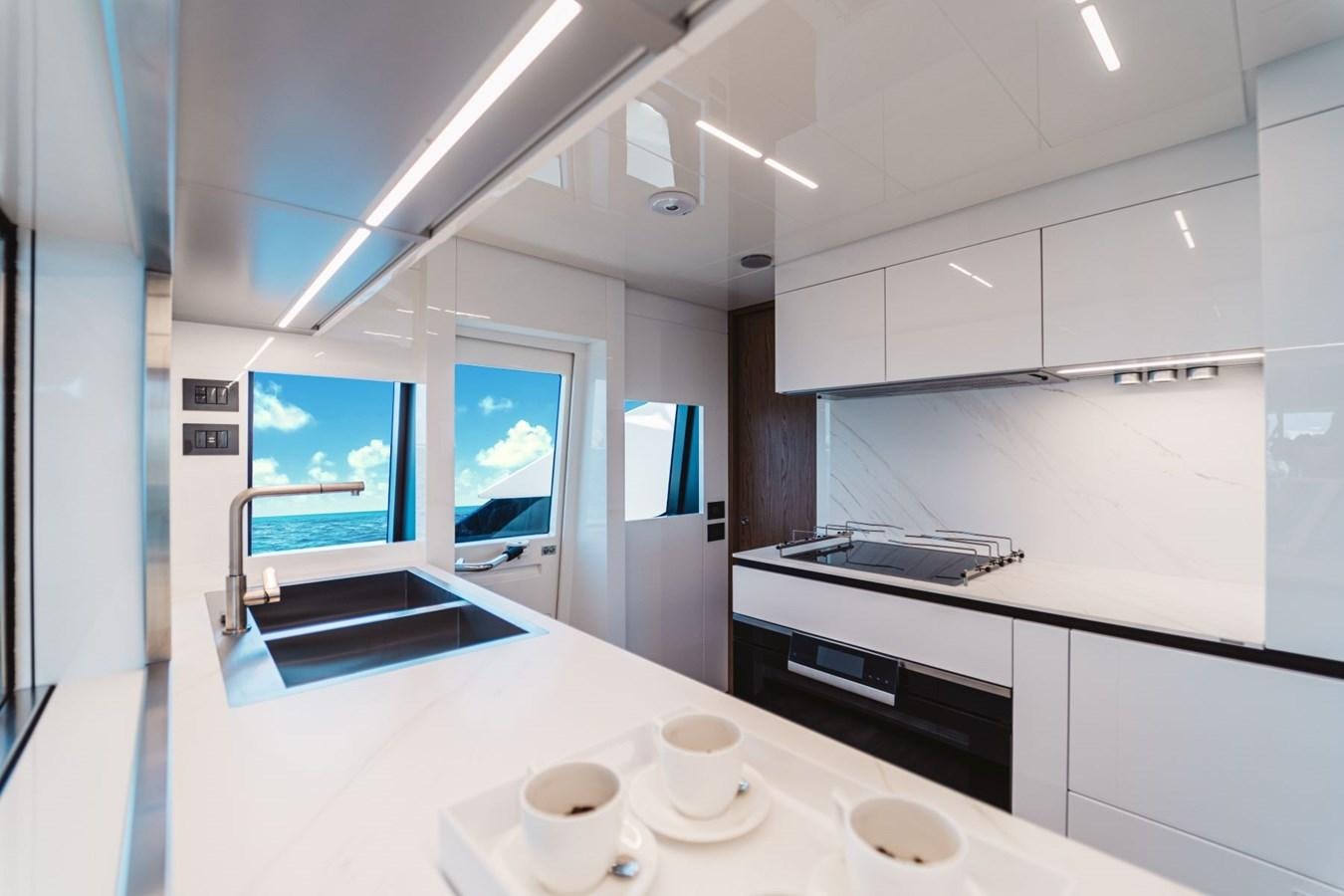 a kitchen with white cabinets aboard FERRETTI YACHTS 920 HT  Yacht for Sale