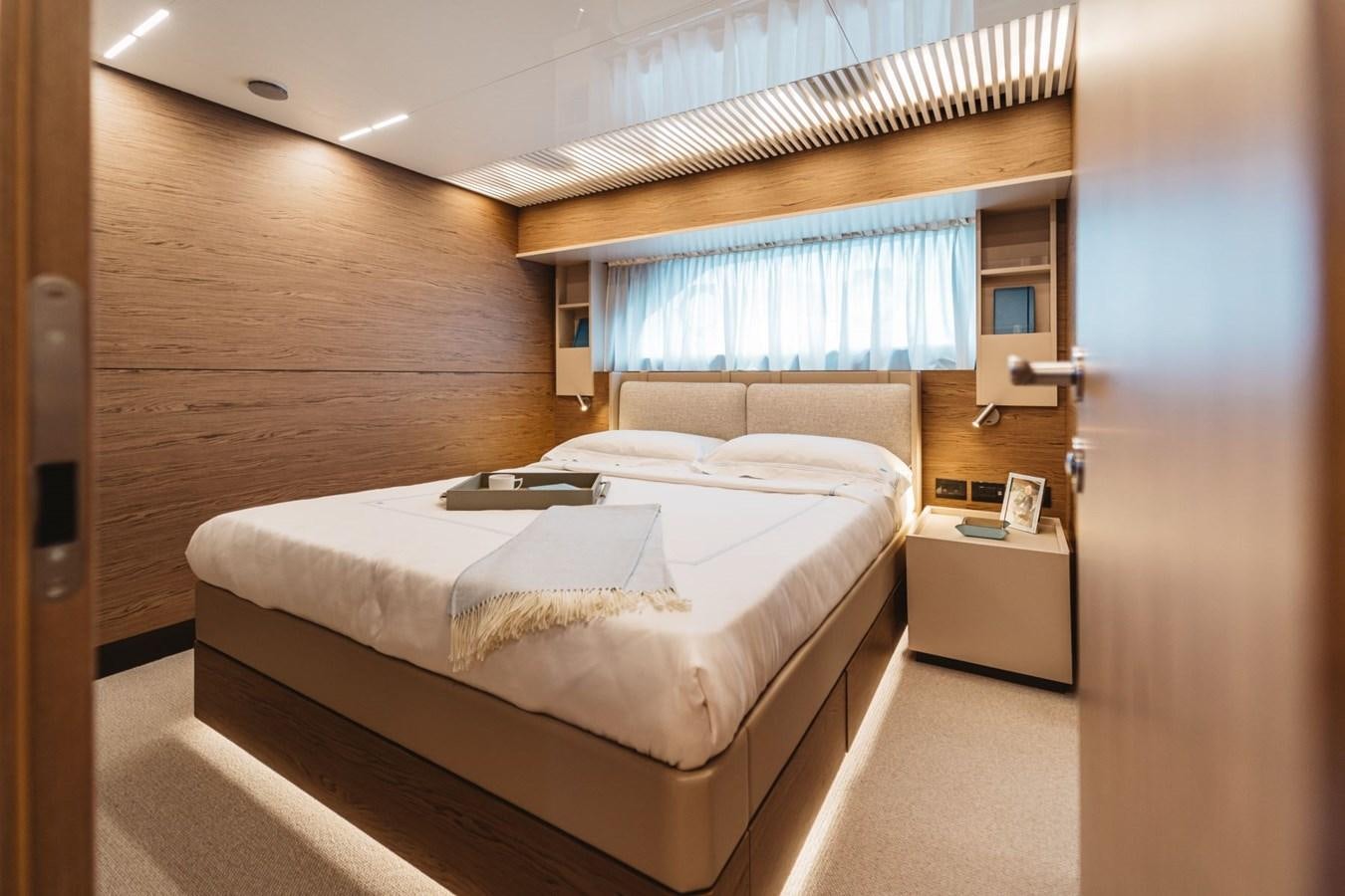 a room with a bed and a desk aboard FERRETTI YACHTS 920 HT  Yacht for Sale