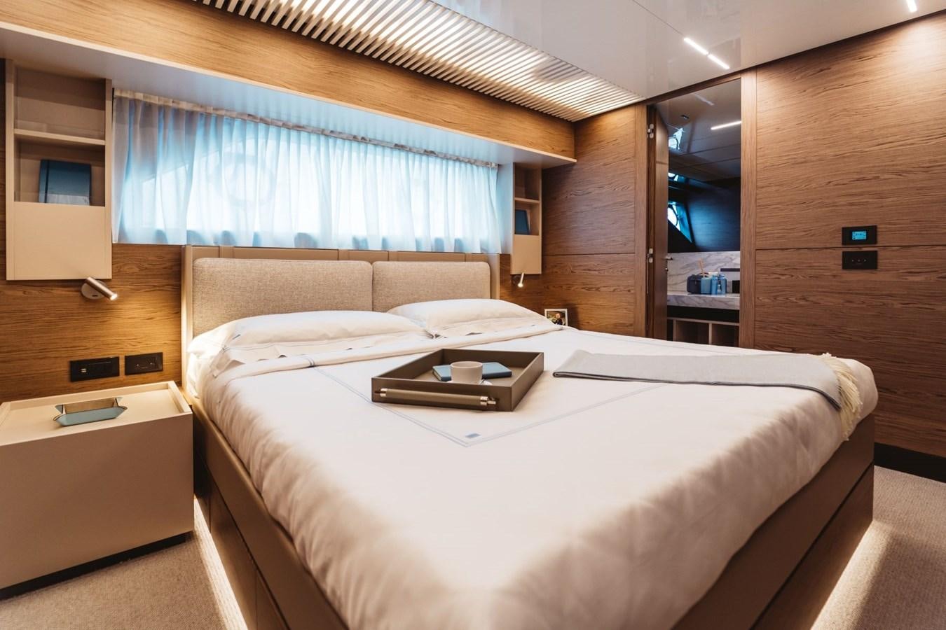 a room with a bed and a desk aboard FERRETTI YACHTS 920 HT  Yacht for Sale
