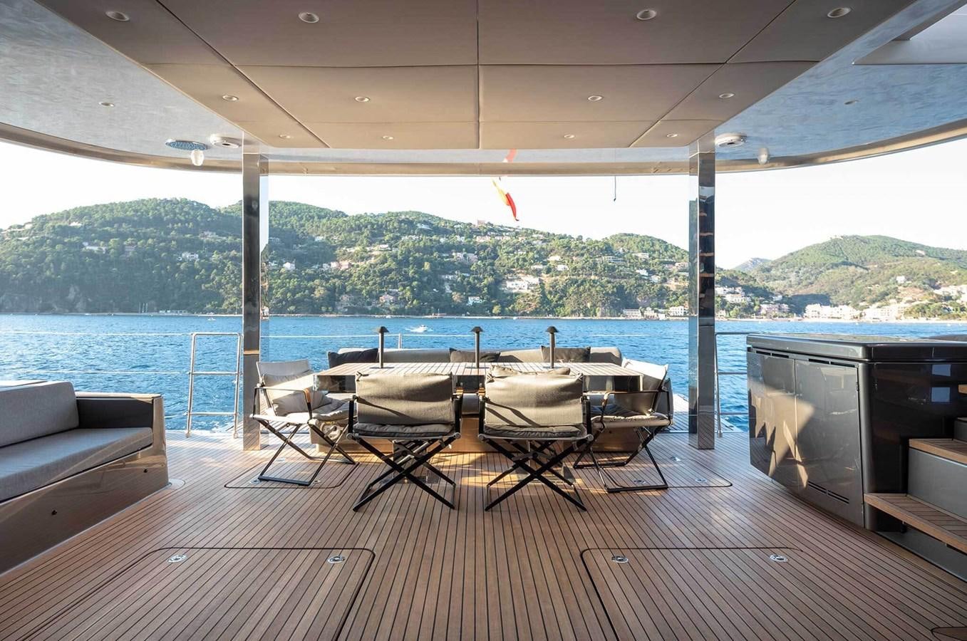 a deck with a table and chairs aboard ANIMA Yacht for Sale