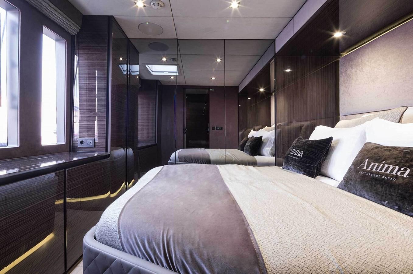 a room with a bed and a window aboard ANIMA Yacht for Sale