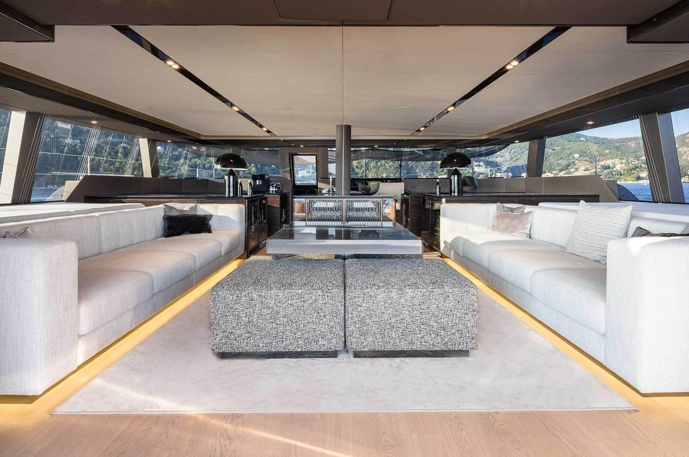 a room with couches and a table aboard ANIMA Yacht for Sale