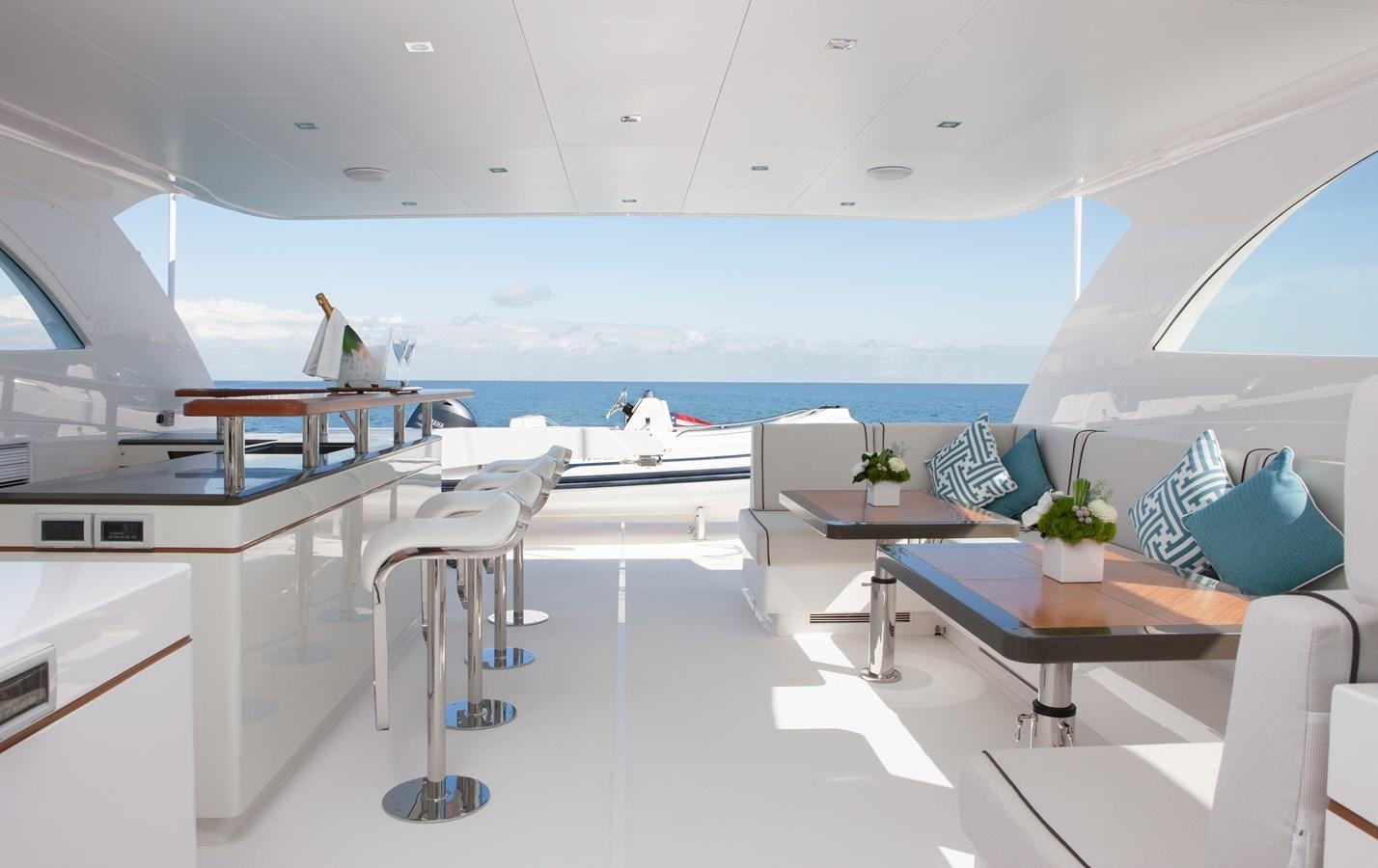 a room with a table chairs and a view of the water aboard HORIZON RP120 Yacht for Sale