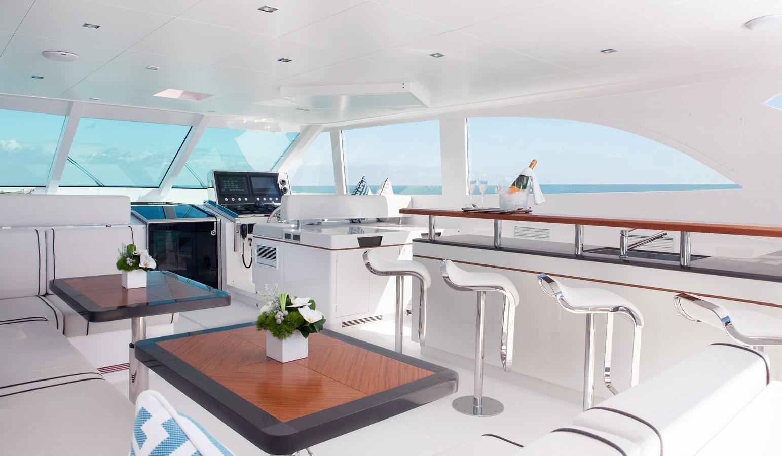a room with a table and chairs aboard HORIZON RP120 Yacht for Sale