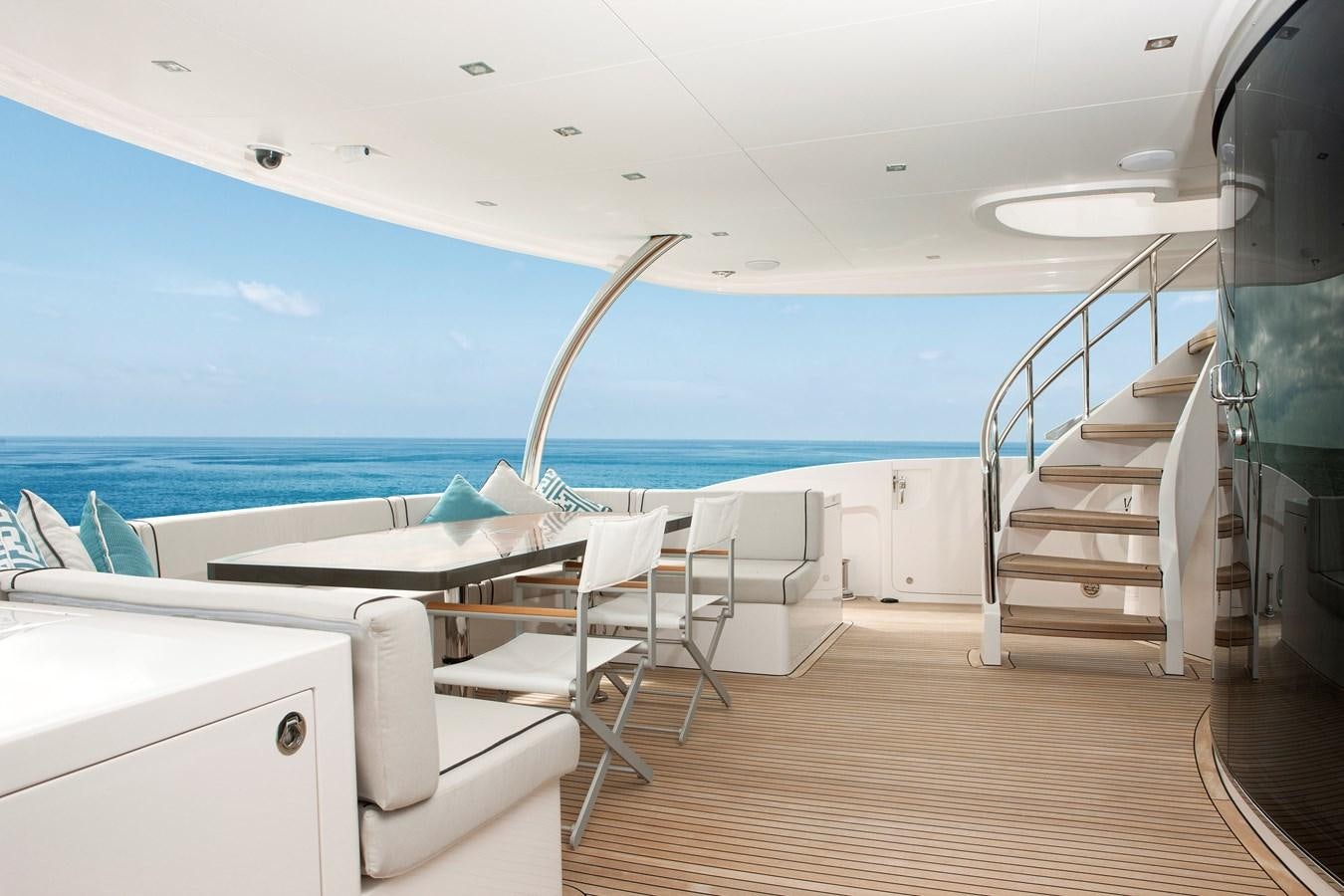 a room with a pool and a deck with chairs and a railing aboard HORIZON RP120 Yacht for Sale