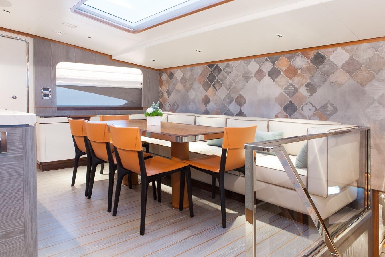 a room with a table and chairs aboard HORIZON RP120 Yacht for Sale