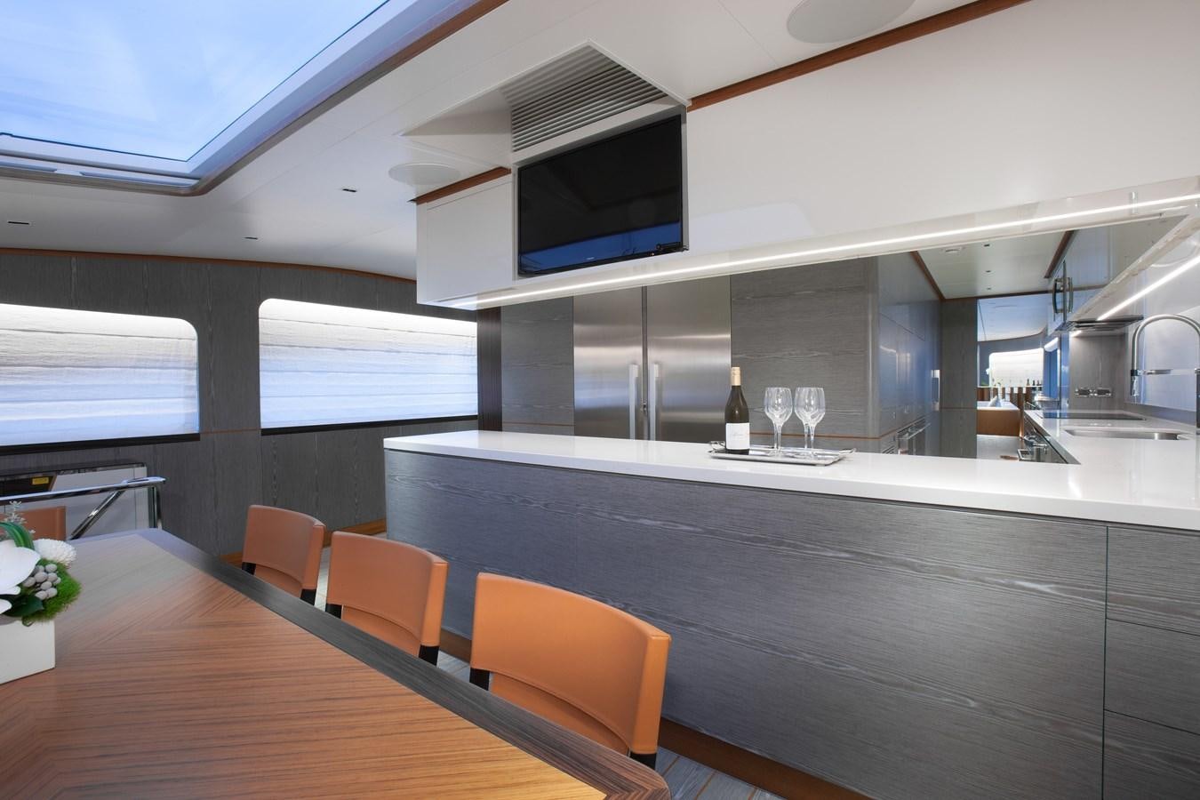 a room with a table and chairs aboard HORIZON RP120 Yacht for Sale