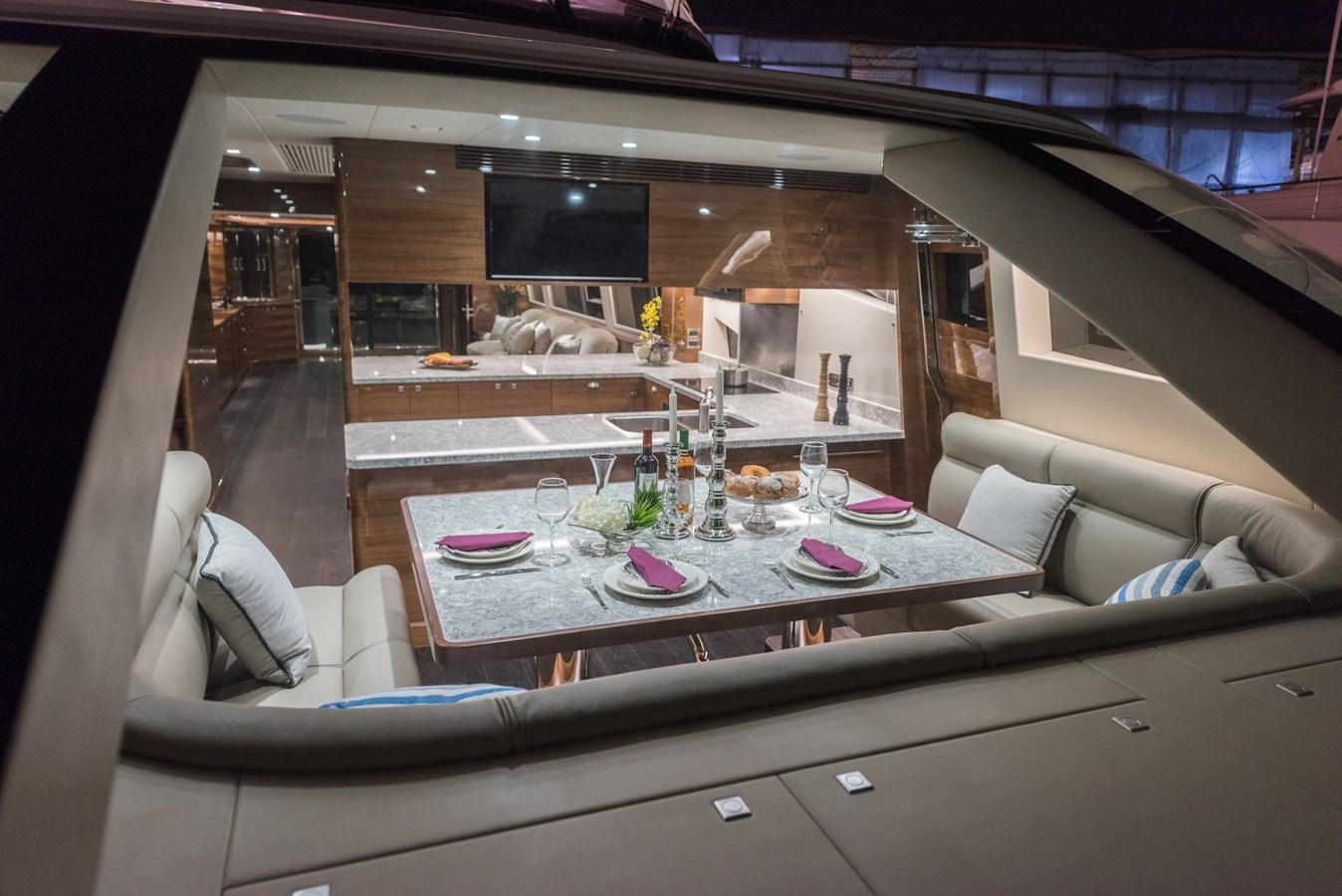 a room with a table and chairs aboard HORIZON E100 Yacht for Sale