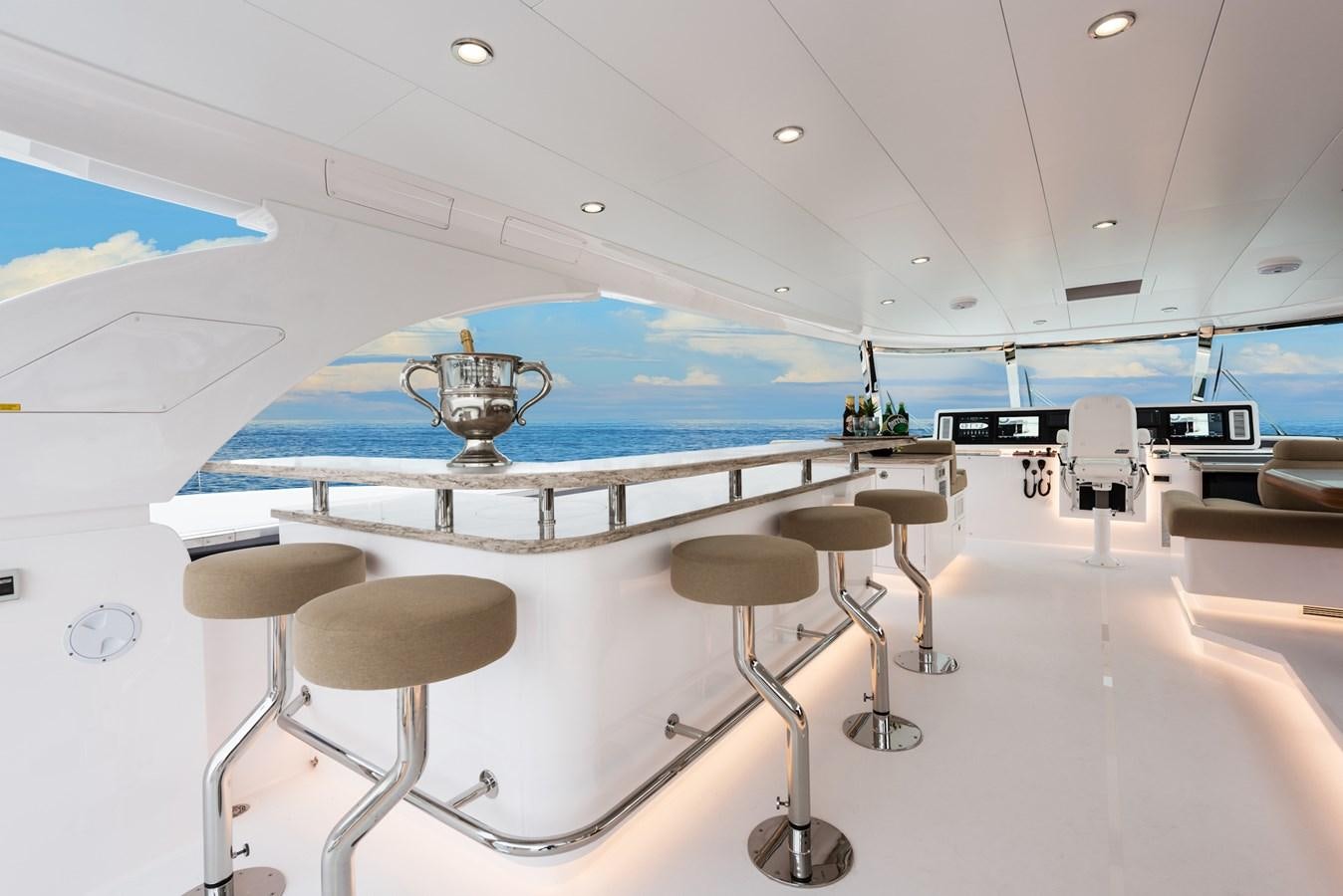 a room with stools and a fan aboard HORIZON E100 Yacht for Sale
