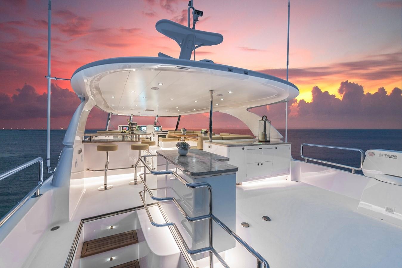 a large white boat with a red and blue sunset behind it aboard HORIZON E100 Yacht for Sale