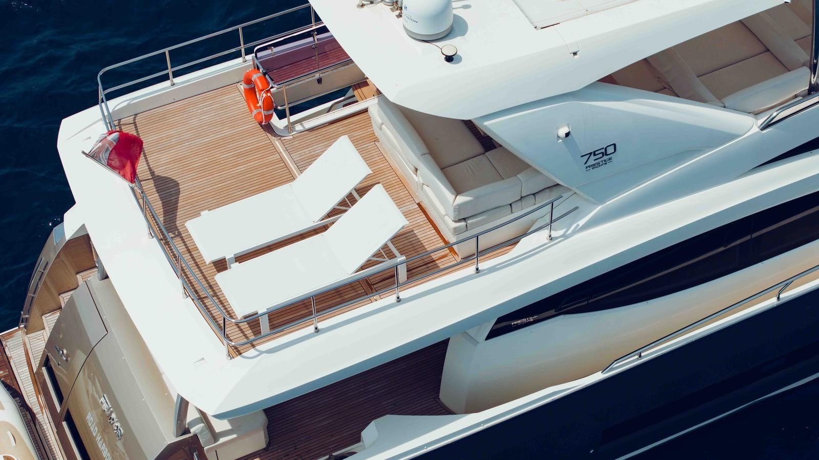 a white boat on a deck aboard FEU D'OR Yacht for Sale