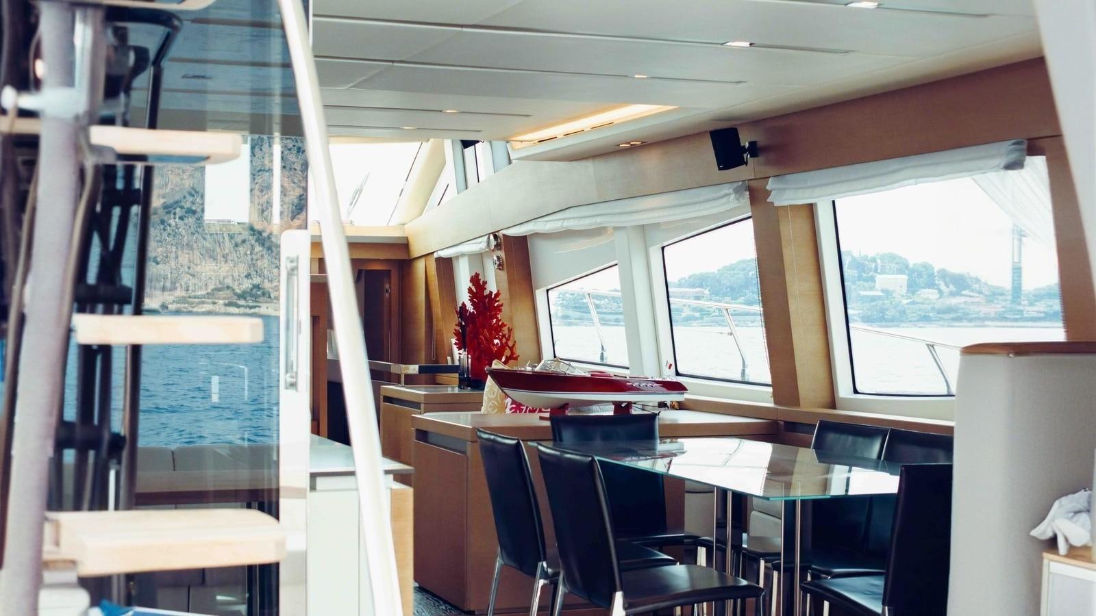 a room with a table and chairs aboard FEU D'OR Yacht for Sale