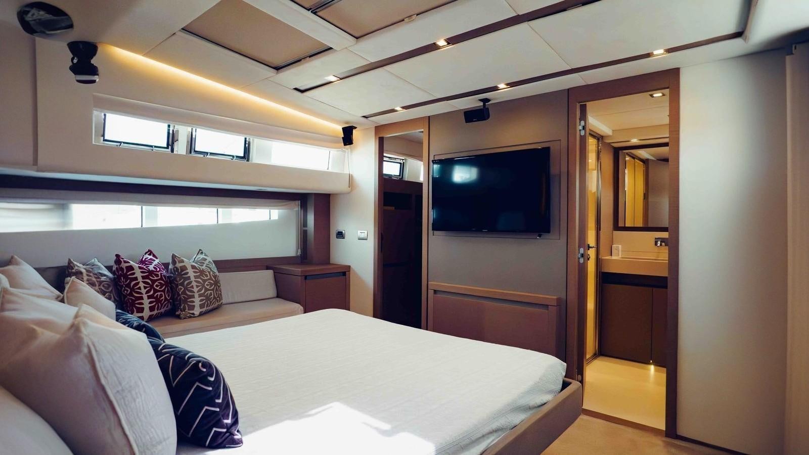 a bedroom with a bed and a television aboard FEU D'OR Yacht for Sale