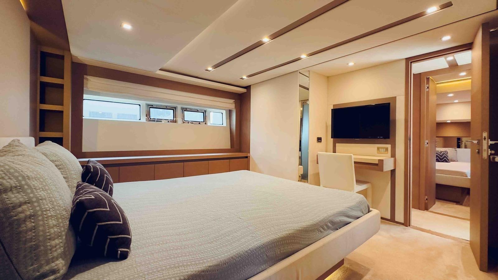 a bedroom with a bed and a tv aboard FEU D'OR Yacht for Sale