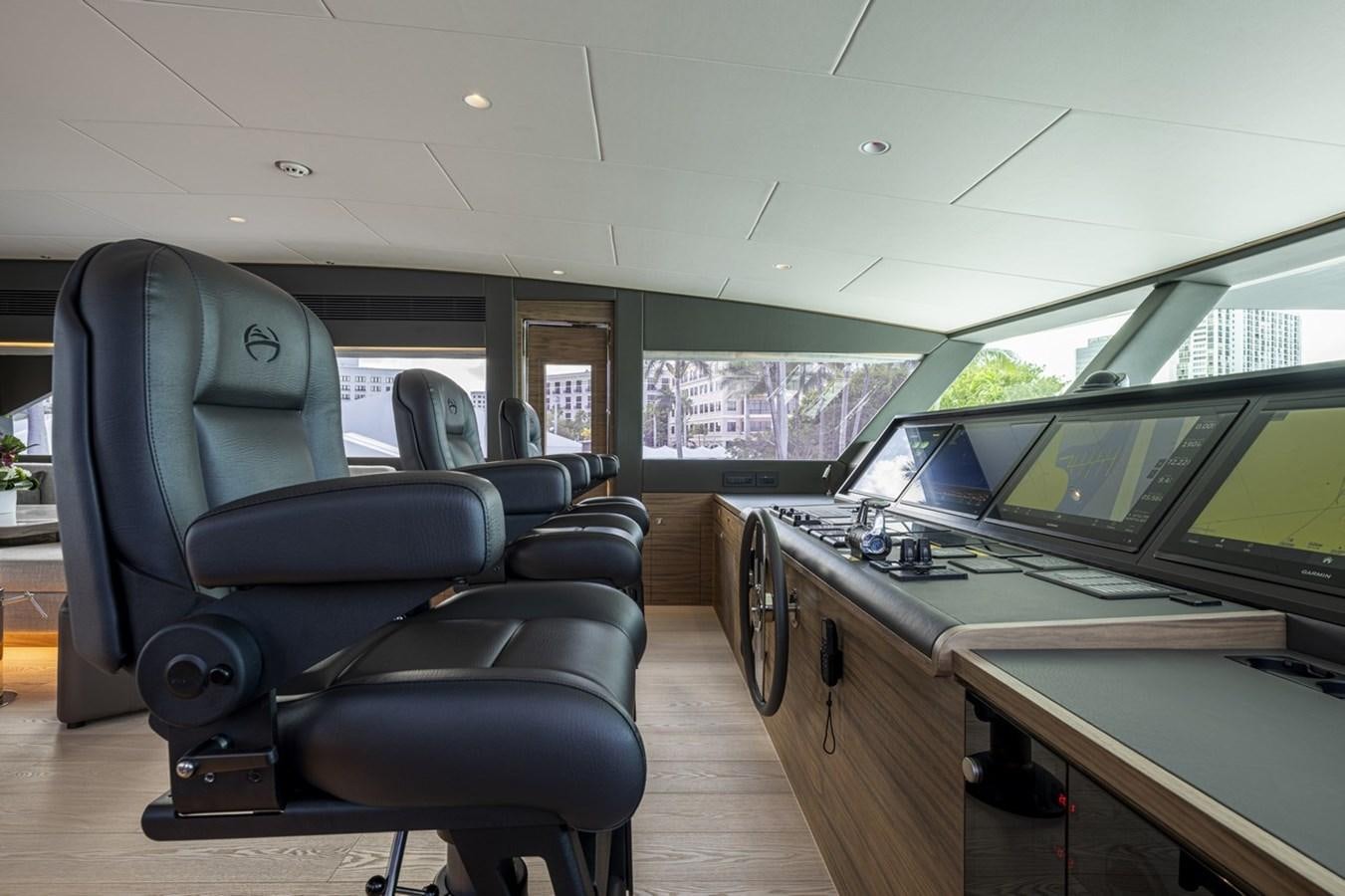 inside of a vehicle with a desk and chairs and computers aboard FD80 Yacht for Sale