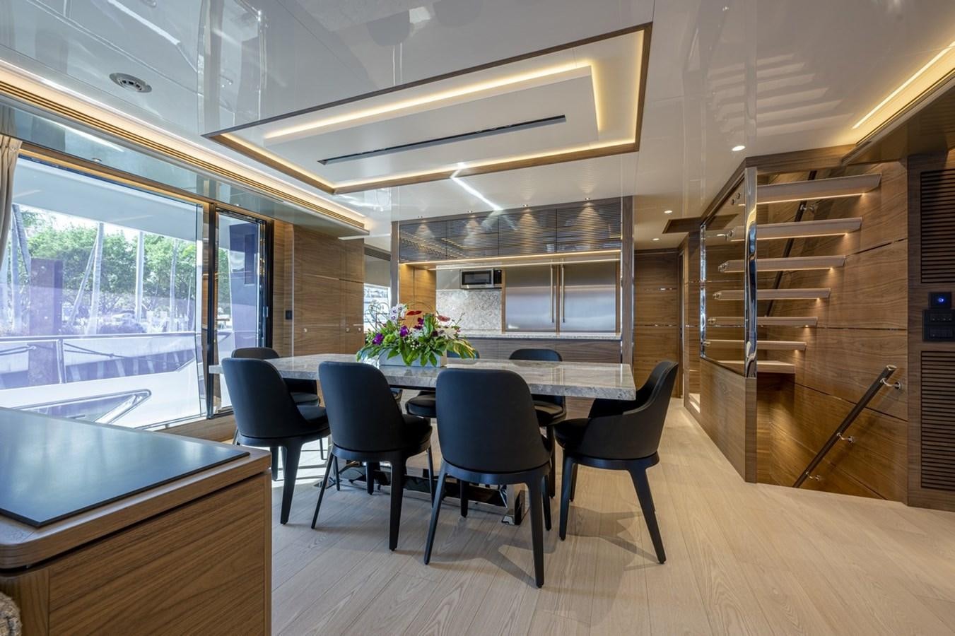 a room with a table and chairs aboard FD80 Yacht for Sale