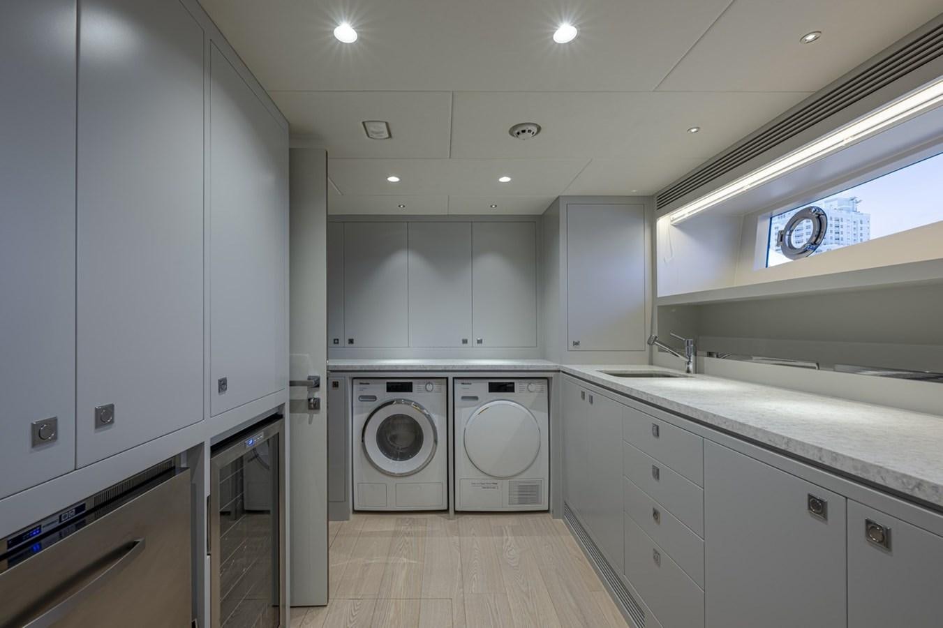 a kitchen with white cabinets aboard FD80 Yacht for Sale