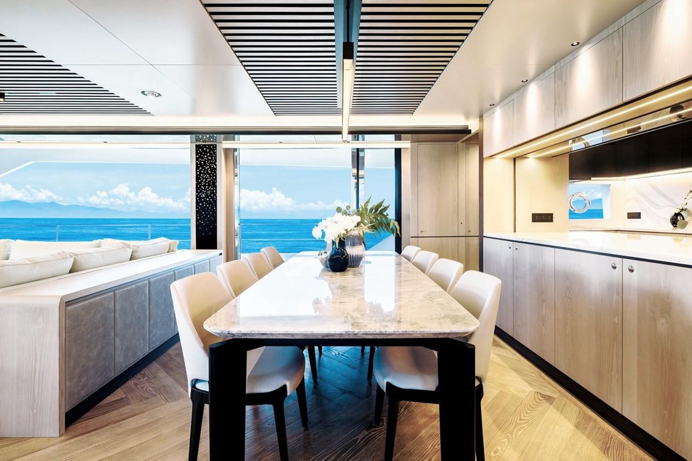 a room with a table and chairs aboard FD80 Yacht for Sale