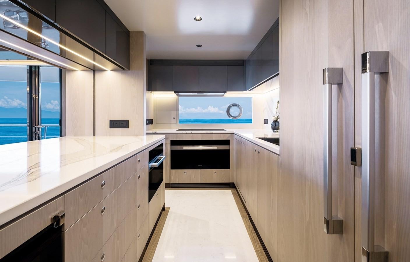 a kitchen with white cabinets aboard FD80 Yacht for Sale