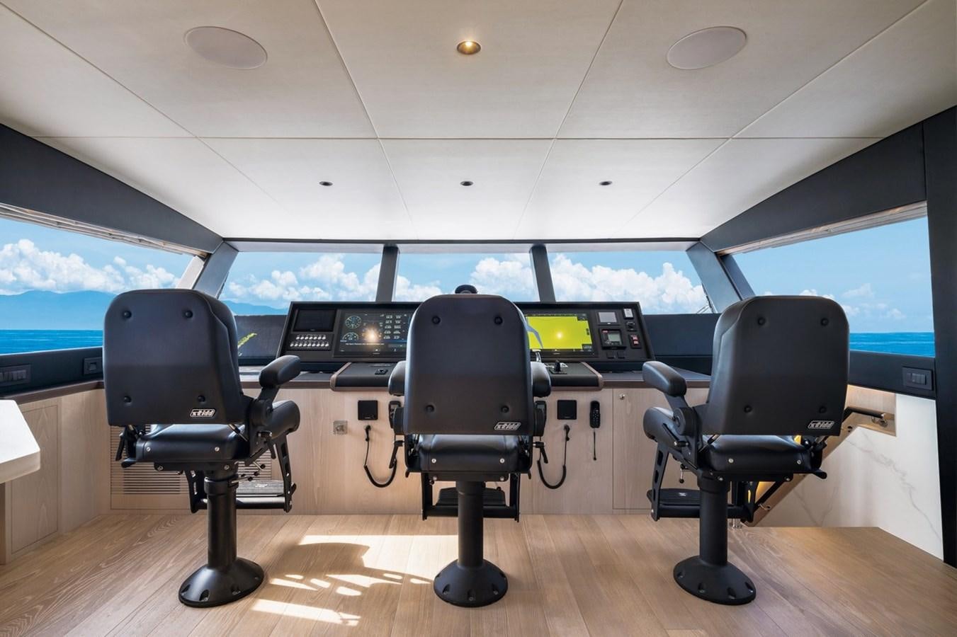a room with chairs and computers aboard FD80 Yacht for Sale