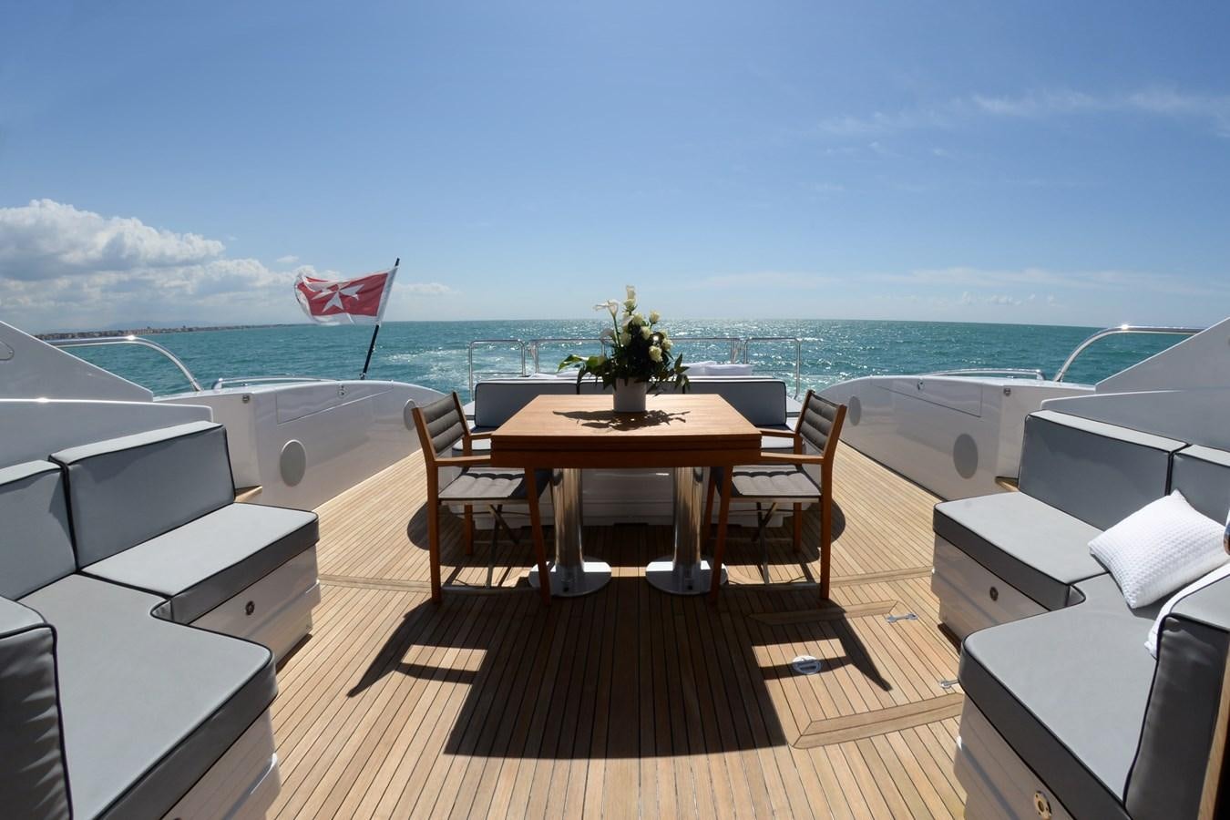 a room with a table and chairs and a view of the ocean aboard ONLY ONE Yacht for Sale