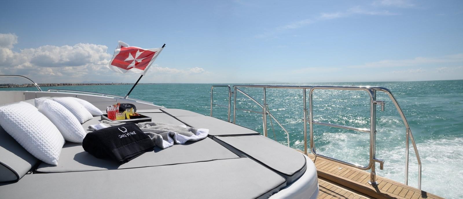 a boat with a flag on the front aboard ONLY ONE Yacht for Sale