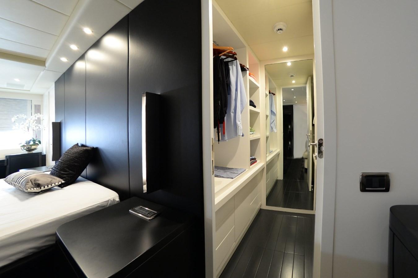 a room with a bed and a mirror aboard ONLY ONE Yacht for Sale