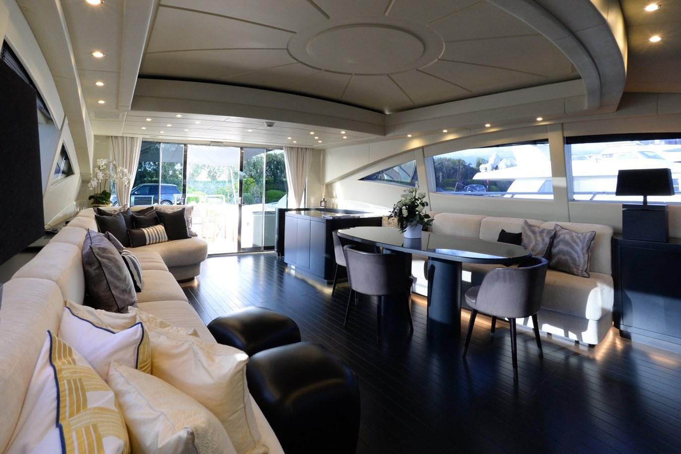 a living room with a table and couches aboard ONLY ONE Yacht for Sale