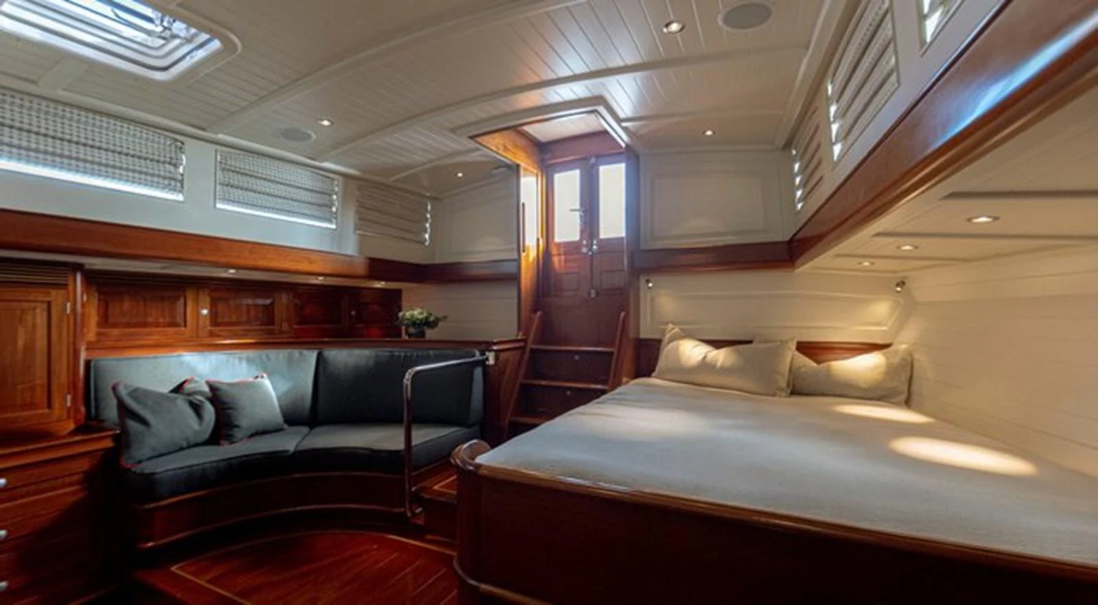 a room with a bed and a couch aboard ATALANTE Yacht for Sale