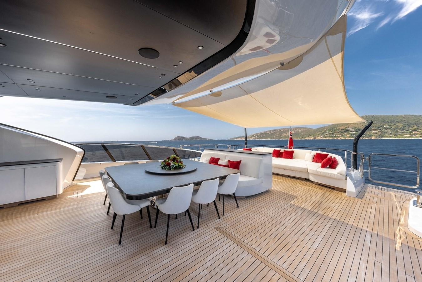 a patio with a table and chairs aboard N1 Yacht for Sale