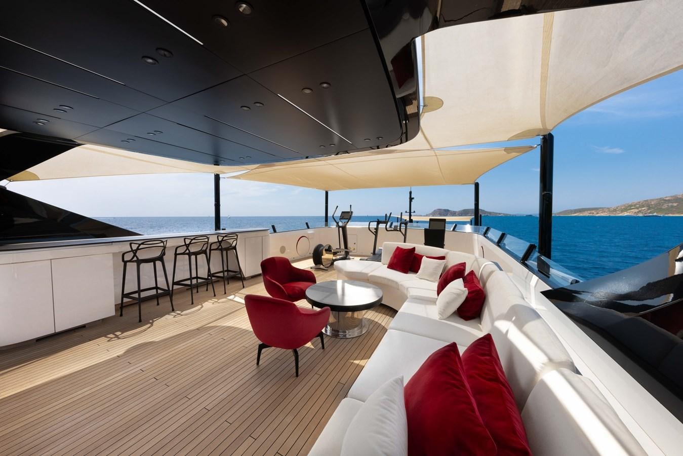 a room with a large bed and a table and chairs aboard N1 Yacht for Sale