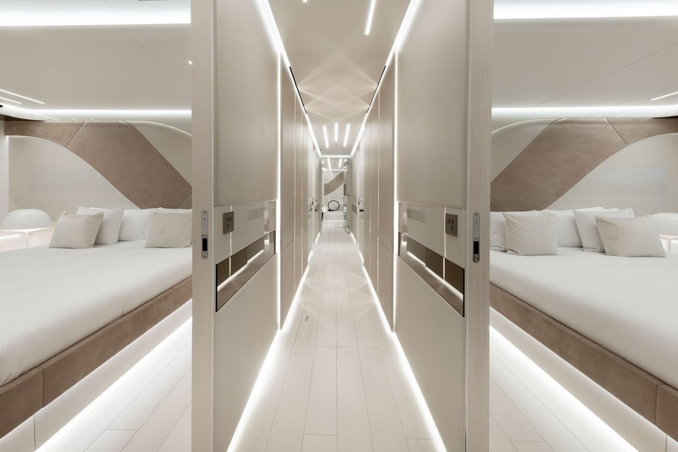 a room with white beds aboard N1 Yacht for Sale