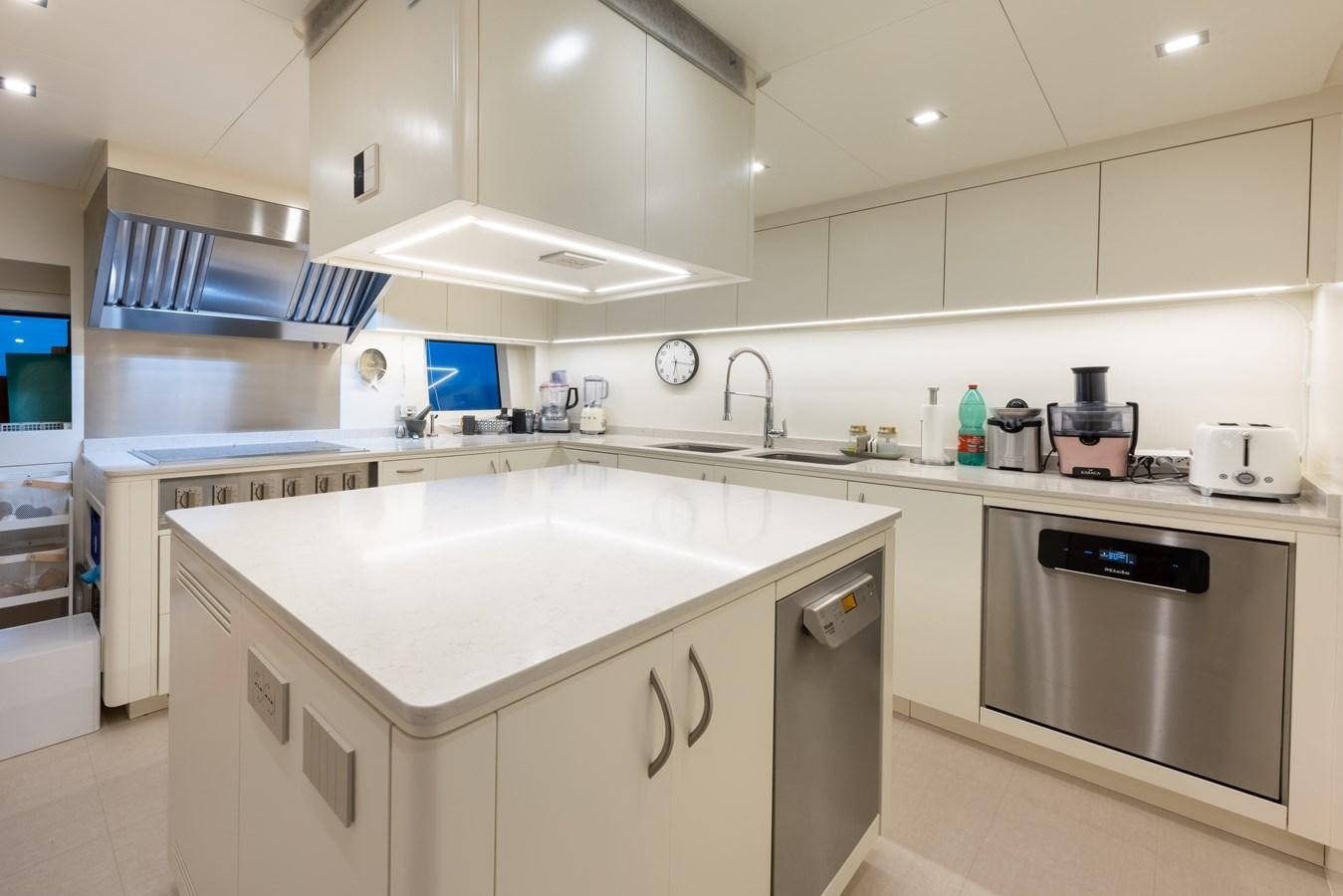 a kitchen with white cabinets aboard N1 Yacht for Sale
