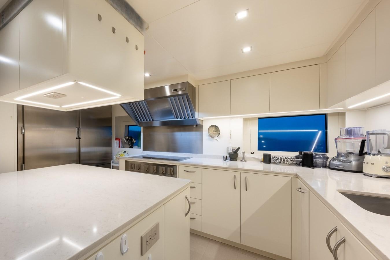 a kitchen with white cabinets aboard N1 Yacht for Sale