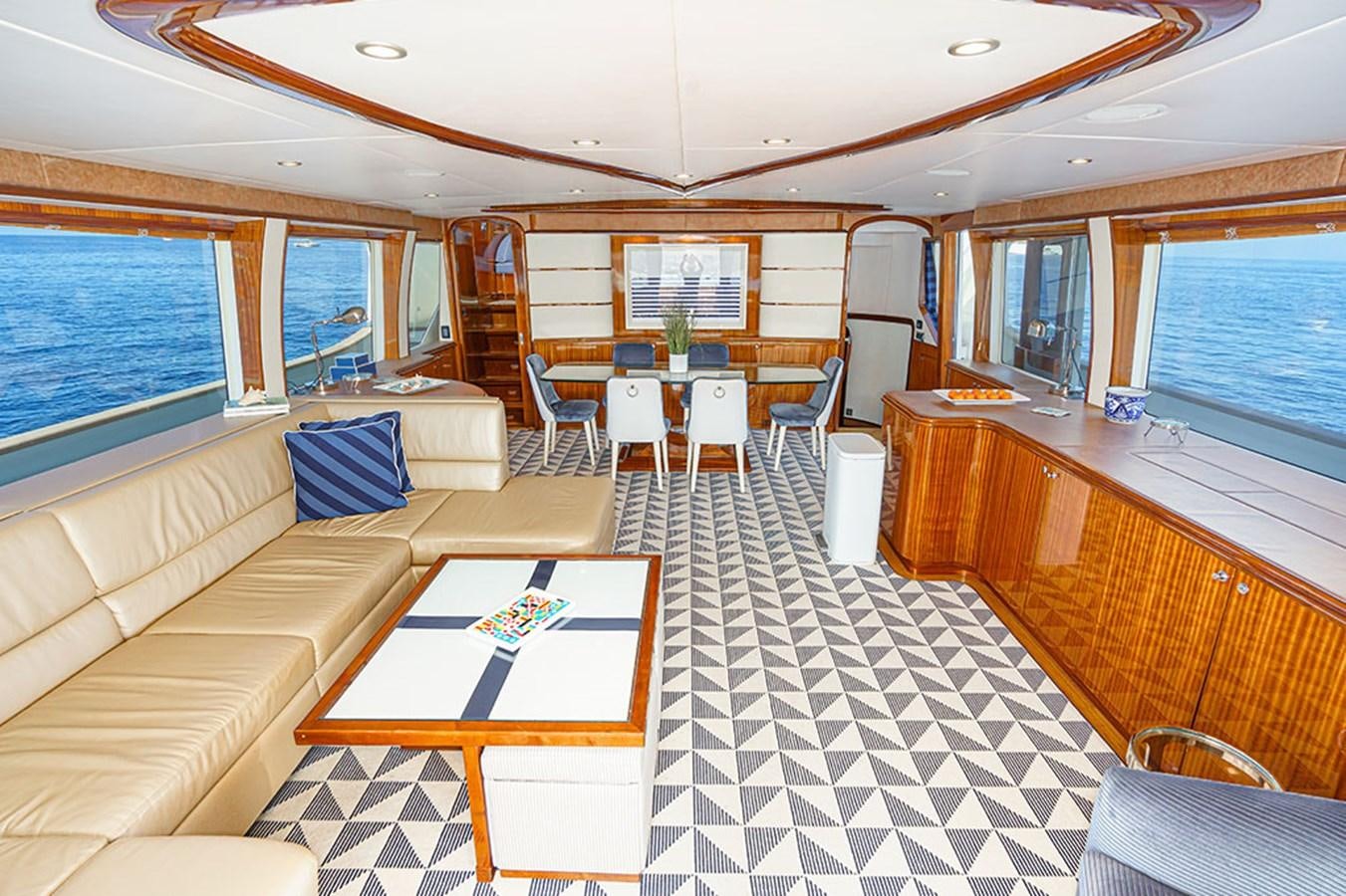 a large room with a table and chairs aboard WICKED COOL Yacht for Sale