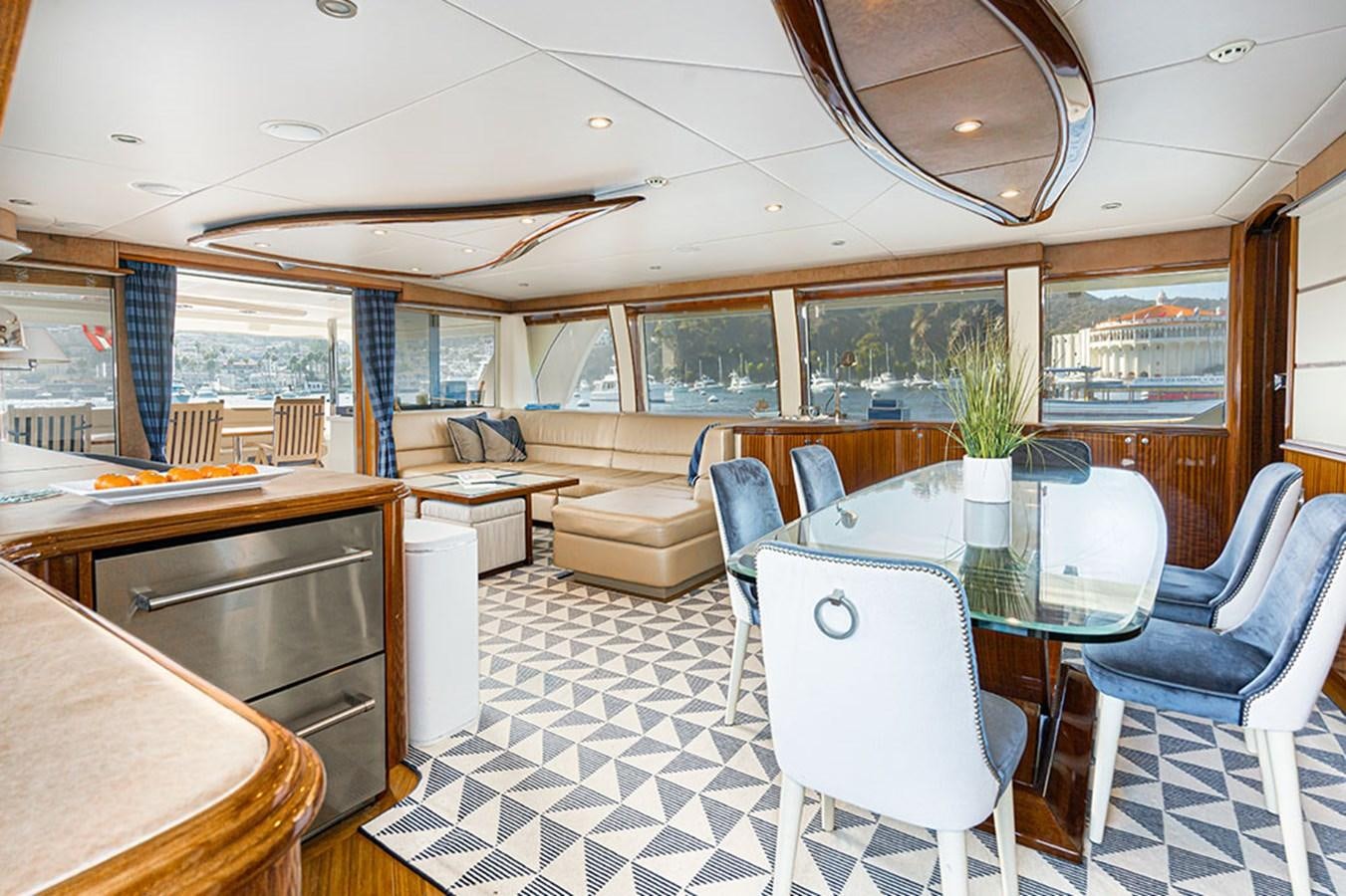 a large room with a table and chairs aboard WICKED COOL Yacht for Sale