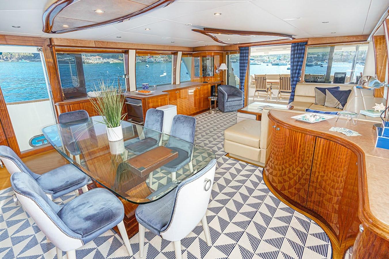 a large room with a table and chairs aboard WICKED COOL Yacht for Sale
