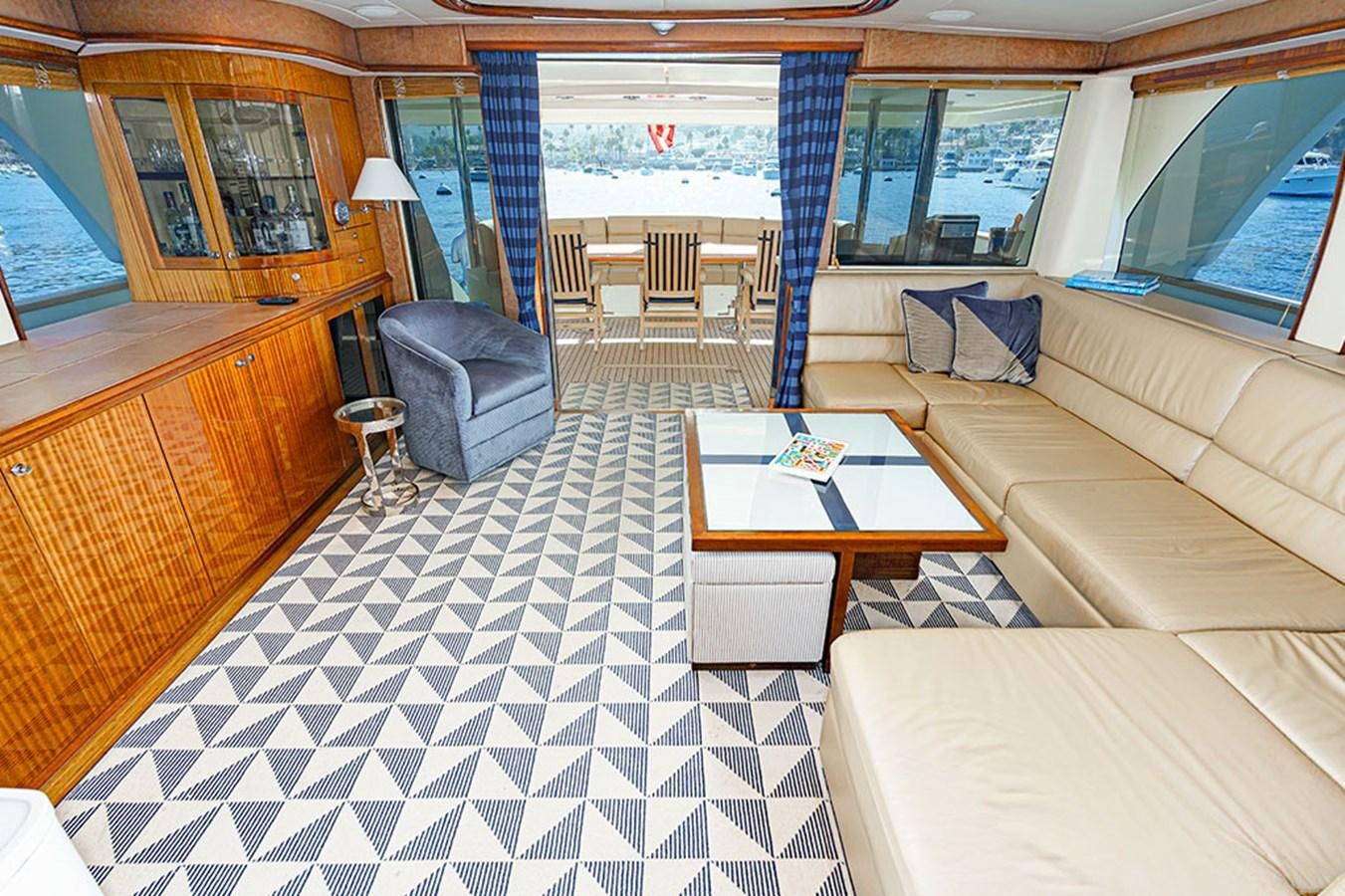 a living room with a table and chairs aboard WICKED COOL Yacht for Sale