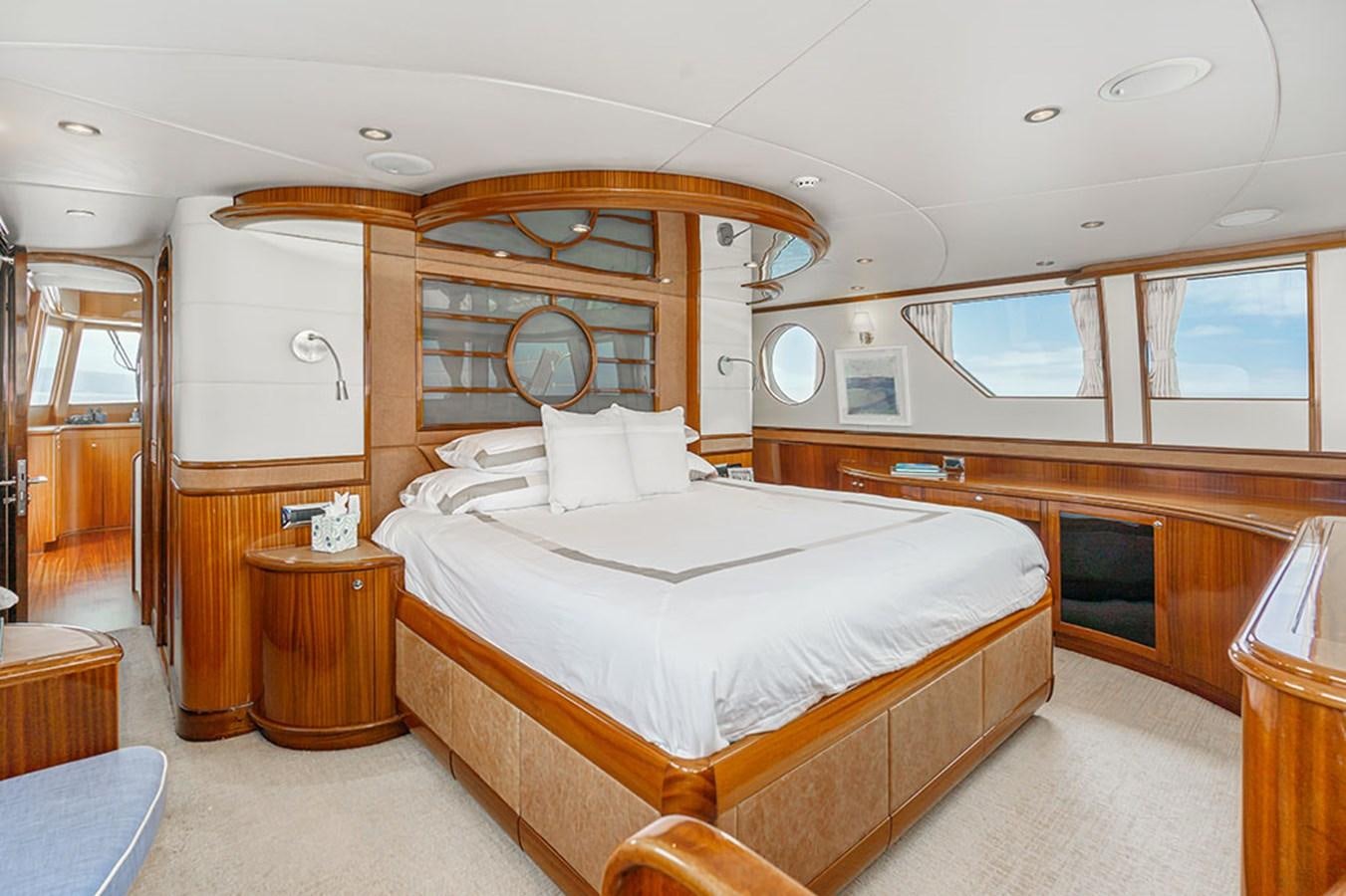 a bedroom with a bed and a mirror aboard WICKED COOL Yacht for Sale