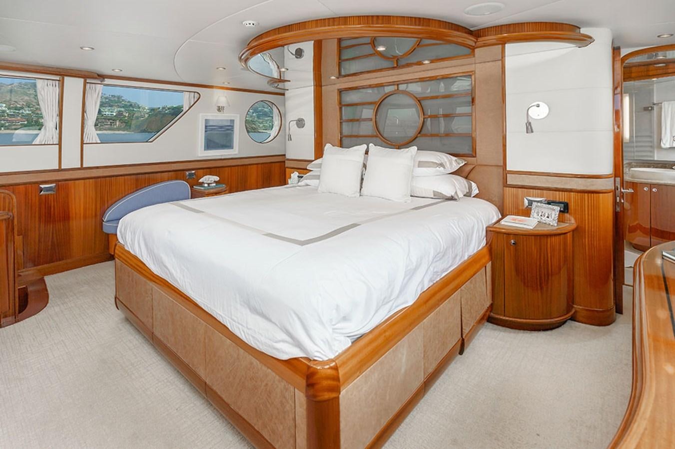 a room with a bed and a mirror aboard WICKED COOL Yacht for Sale