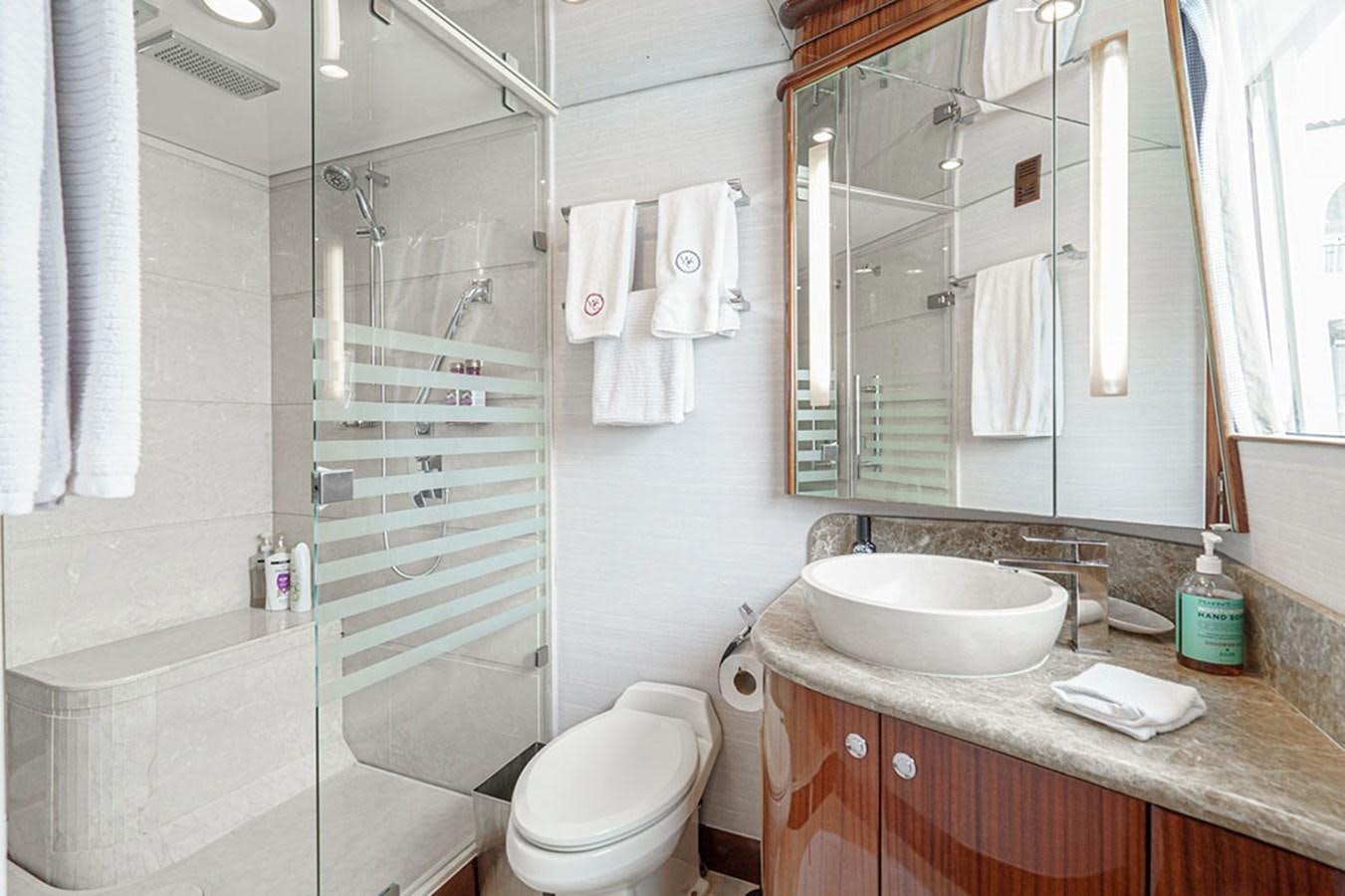 a bathroom with a sink and a toilet aboard WICKED COOL Yacht for Sale