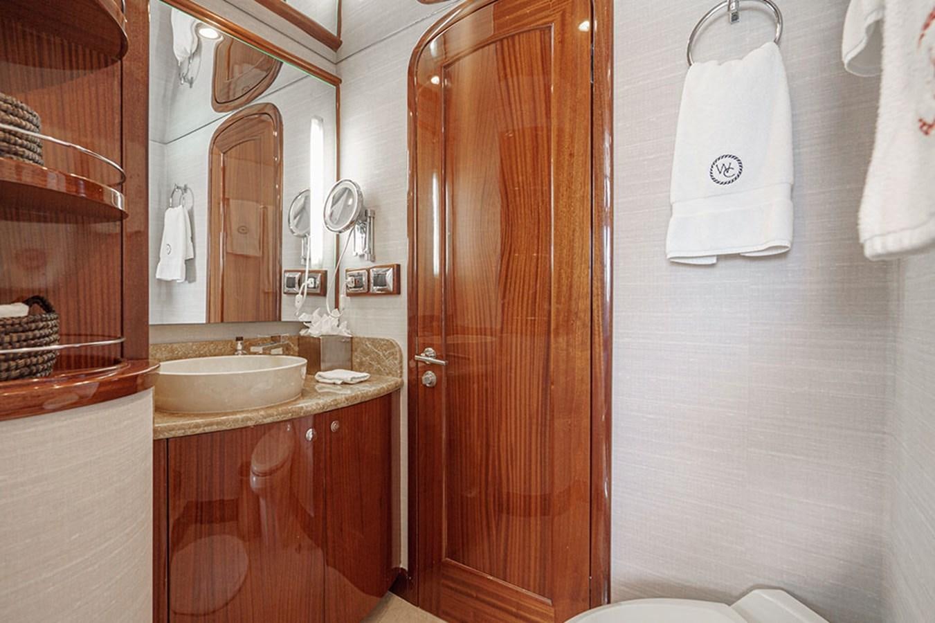 a bathroom with a sink and a mirror aboard WICKED COOL Yacht for Sale