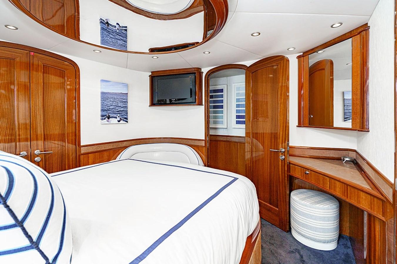 a bedroom with a bed and a television aboard WICKED COOL Yacht for Sale