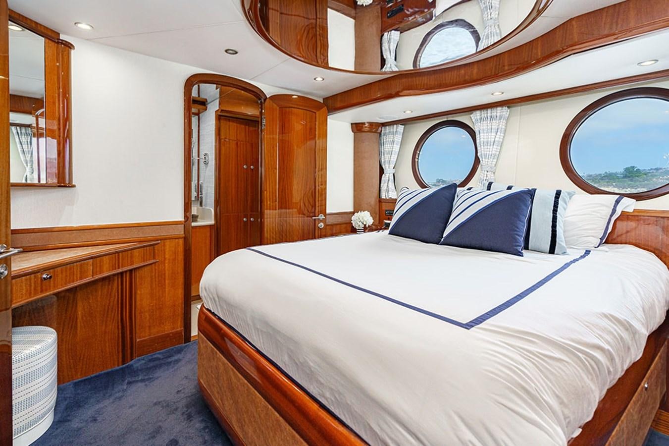 a bed with blue sheets aboard WICKED COOL Yacht for Sale