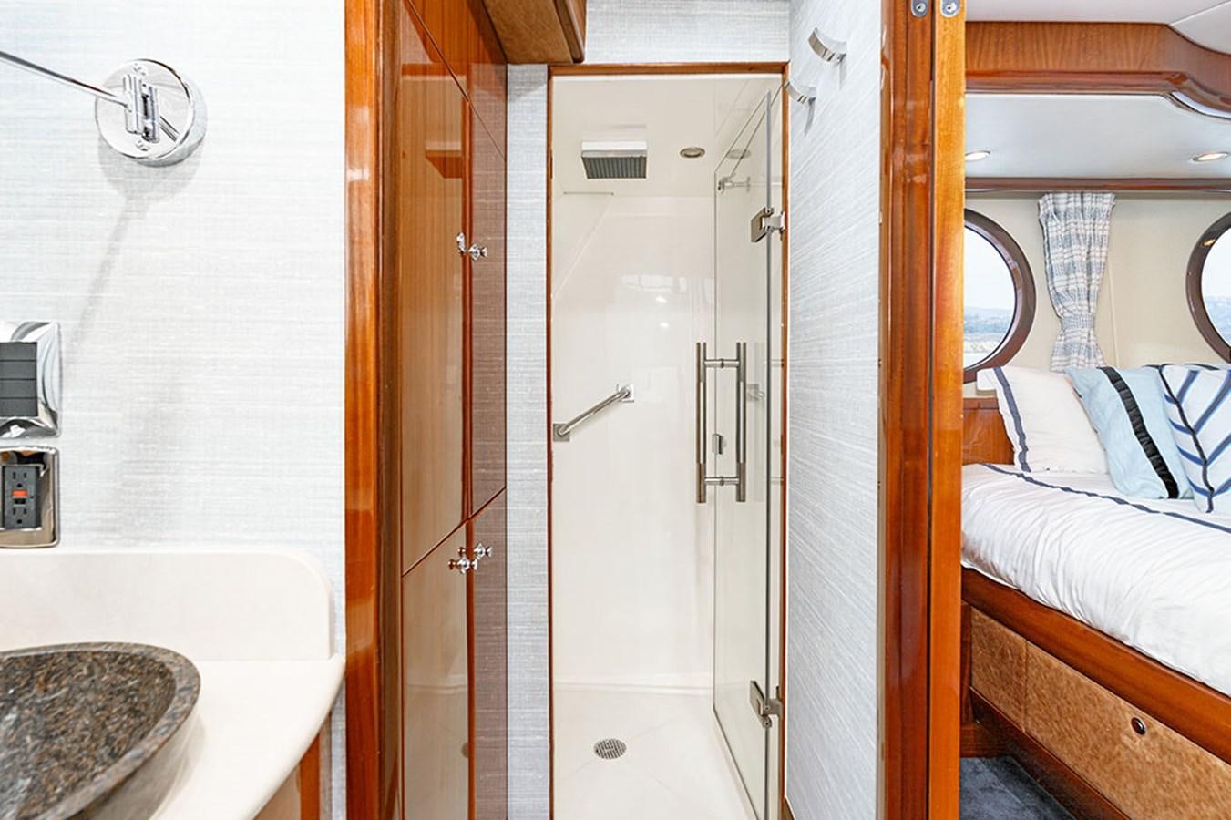 a bathroom with a glass shower aboard WICKED COOL Yacht for Sale