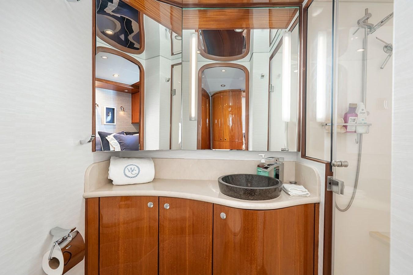 a bathroom with a sink and mirror aboard WICKED COOL Yacht for Sale