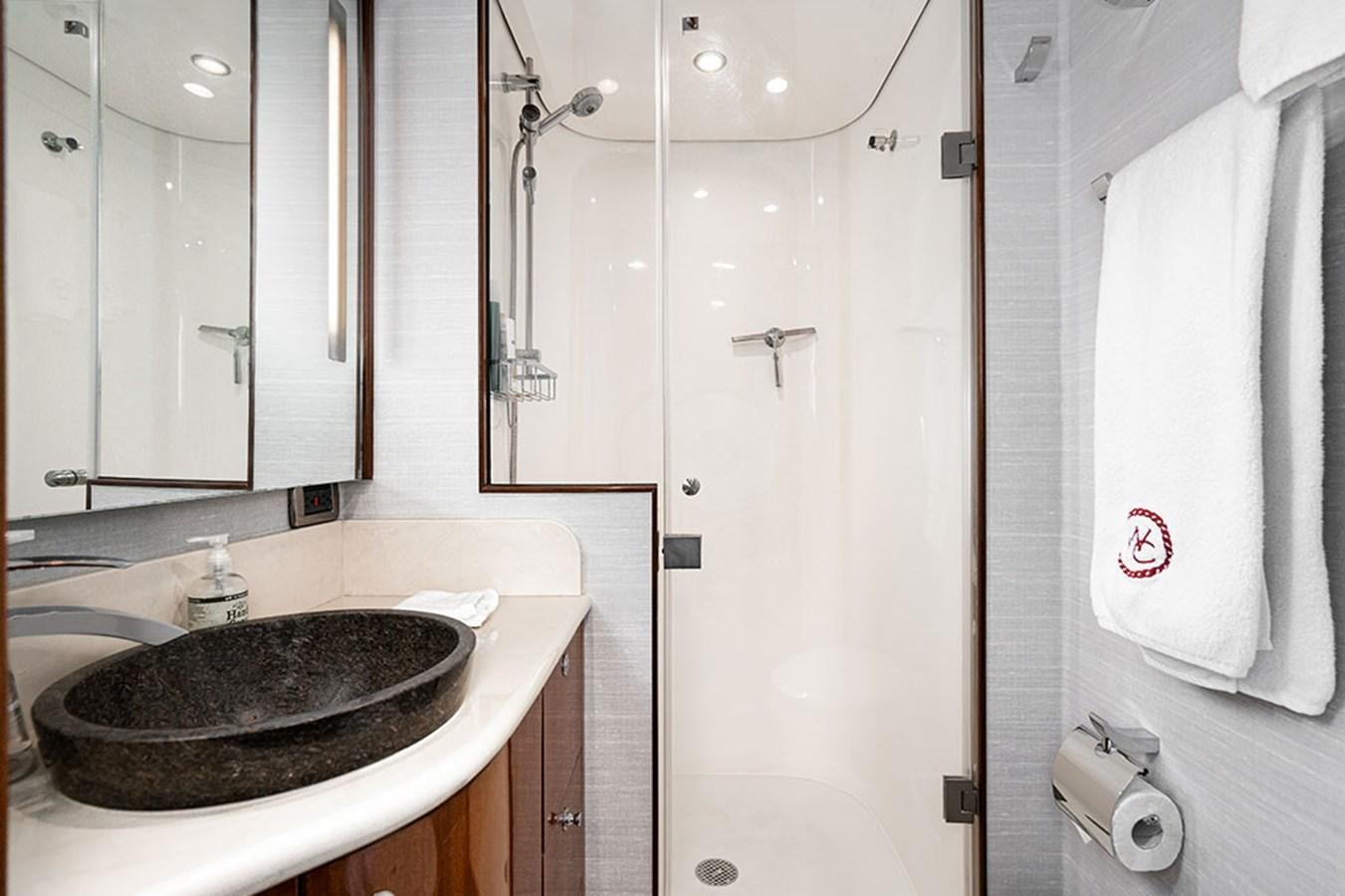 a bathroom with a sink and a mirror aboard WICKED COOL Yacht for Sale