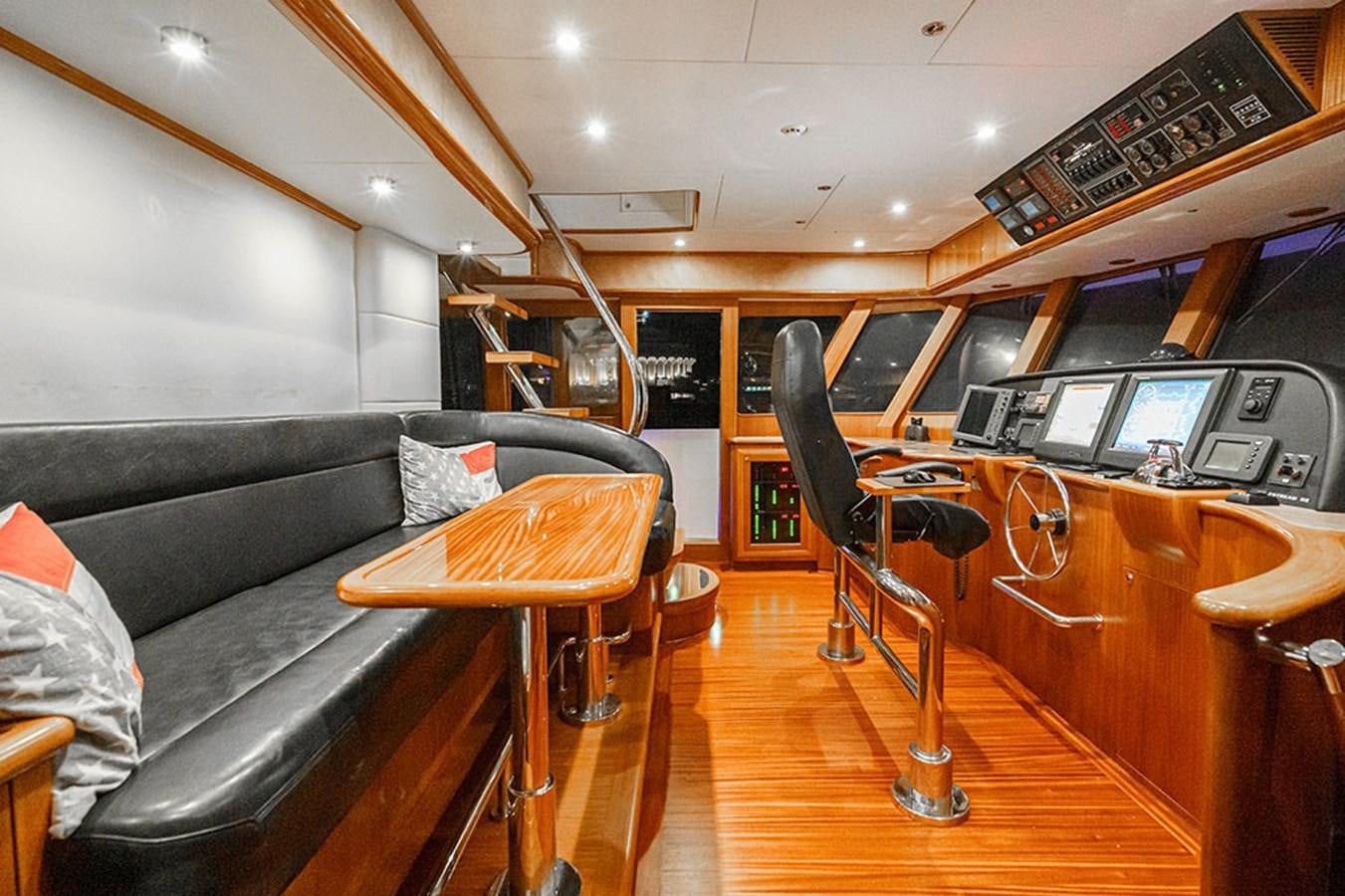 a room with a couch and a desk with a computer on it aboard WICKED COOL Yacht for Sale