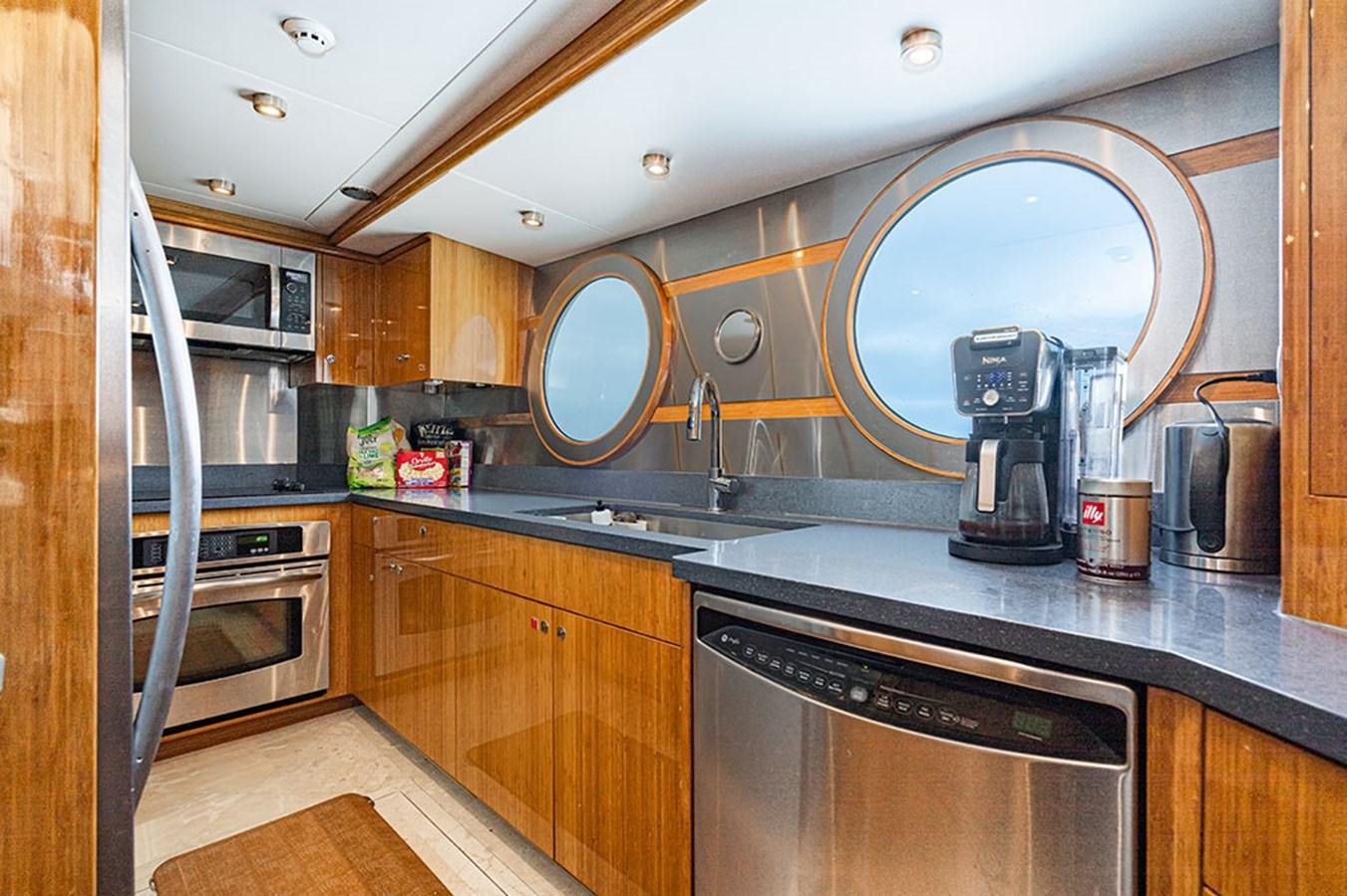 a kitchen with a large mirror aboard WICKED COOL Yacht for Sale