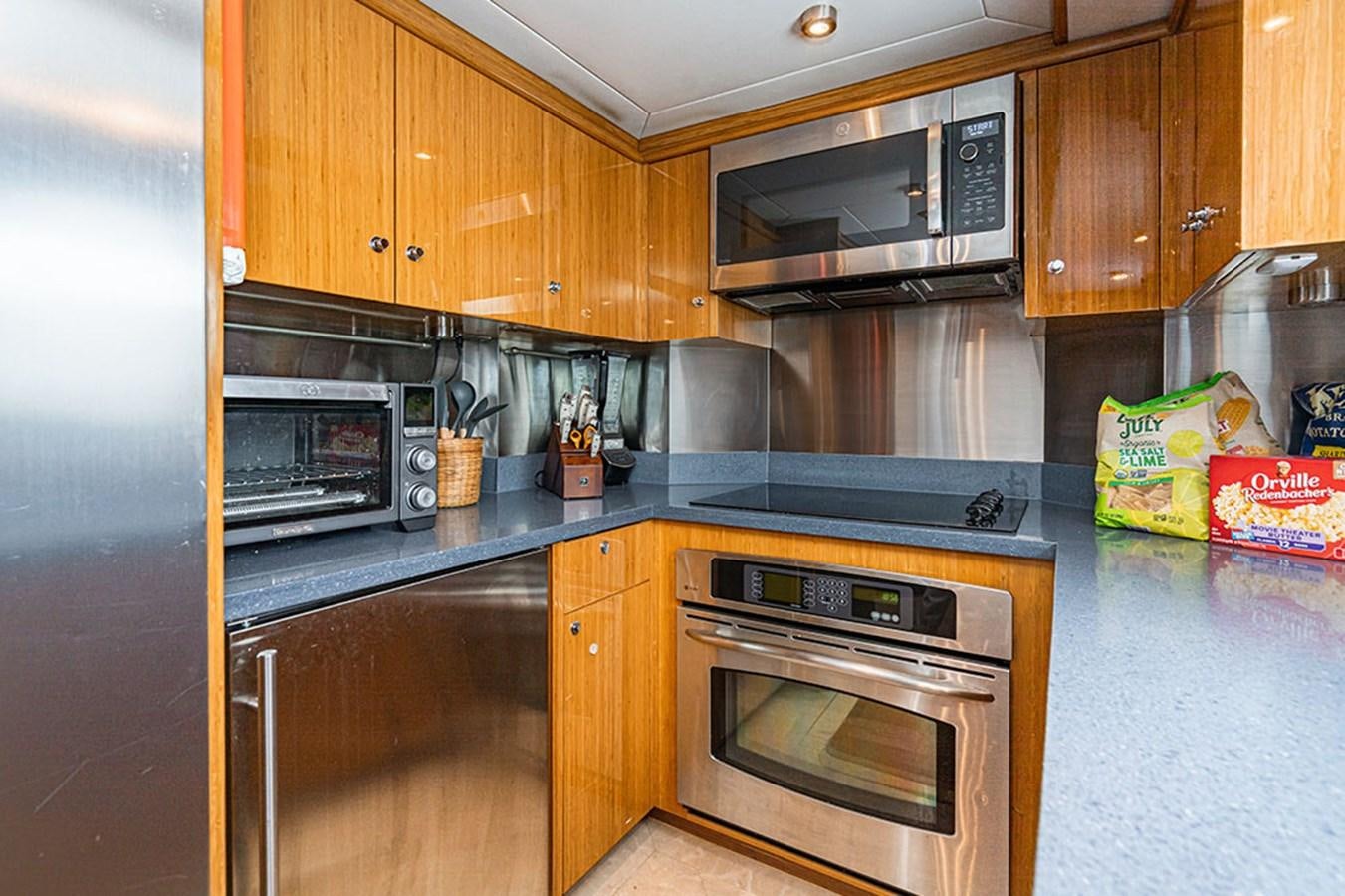 a kitchen with wooden cabinets aboard WICKED COOL Yacht for Sale
